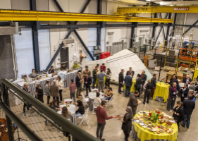 A photo looking down on a group of people as they eat and talk